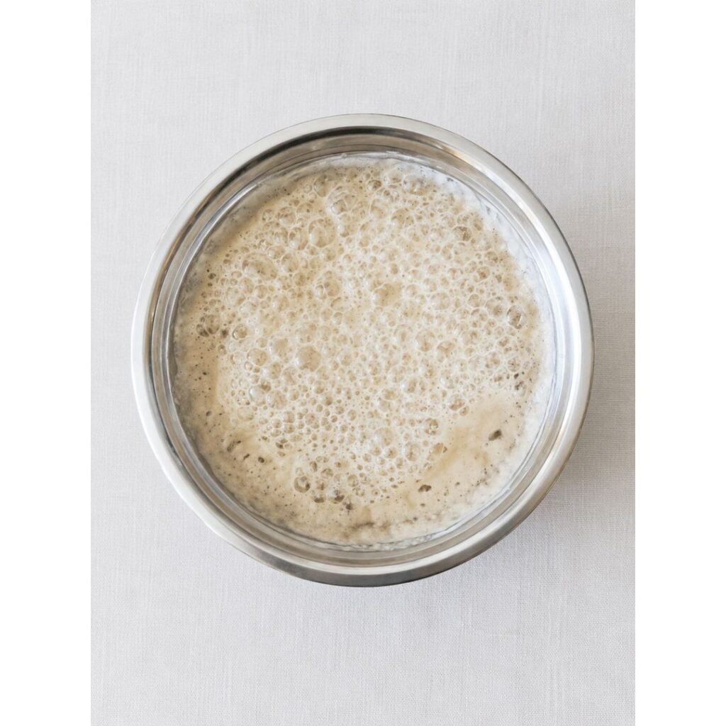 Mixing bread flour into the pizza dough