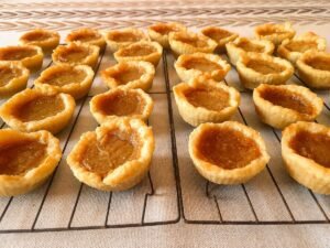 Side view of butter tarts showing the flaky pastry shell and set filling